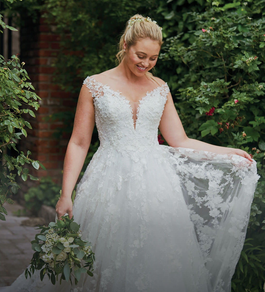 Plus size model wearing a white gown