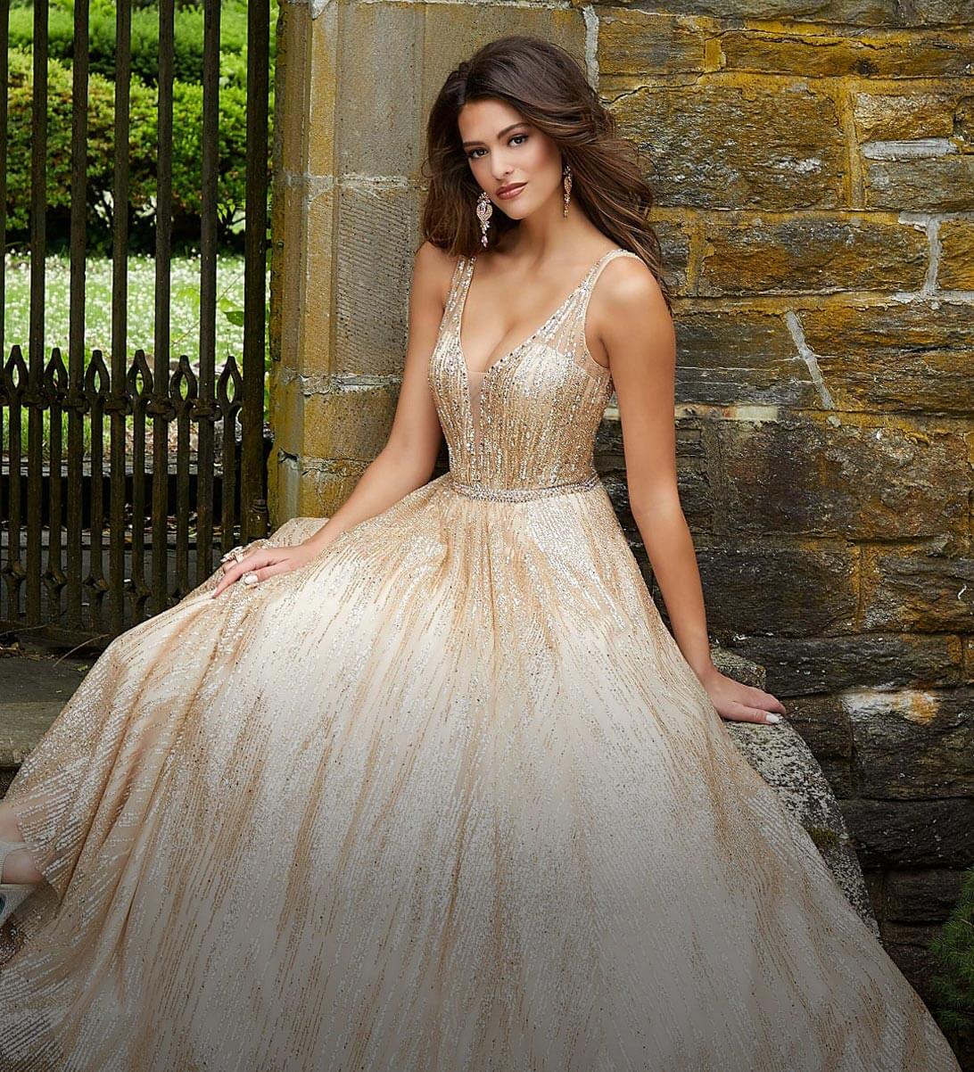 Model wearing a golden prom dress