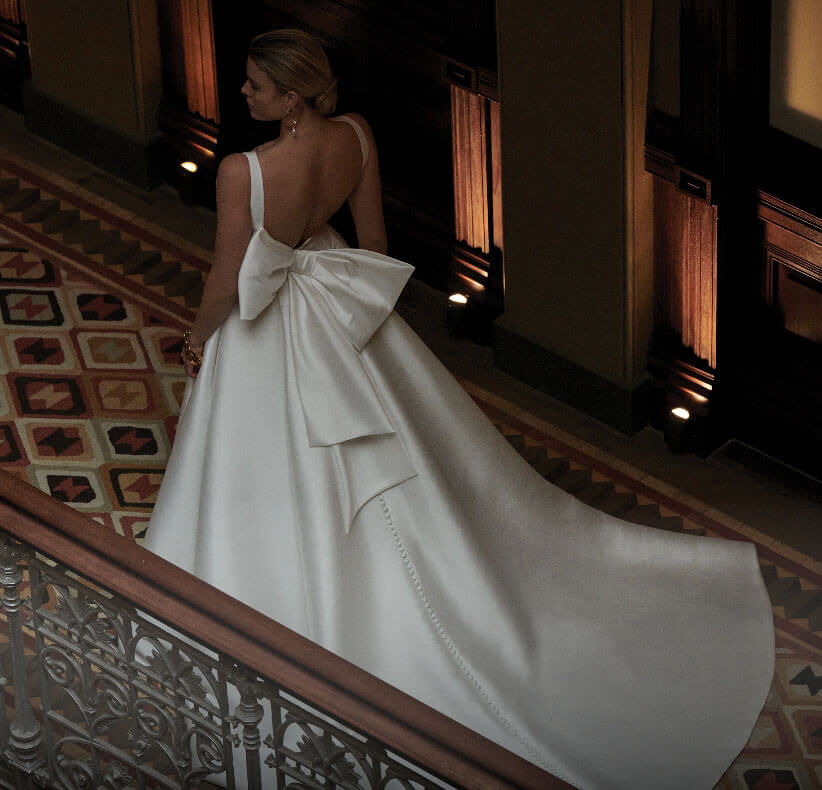 Model wearing a white Ballgown Style Gown