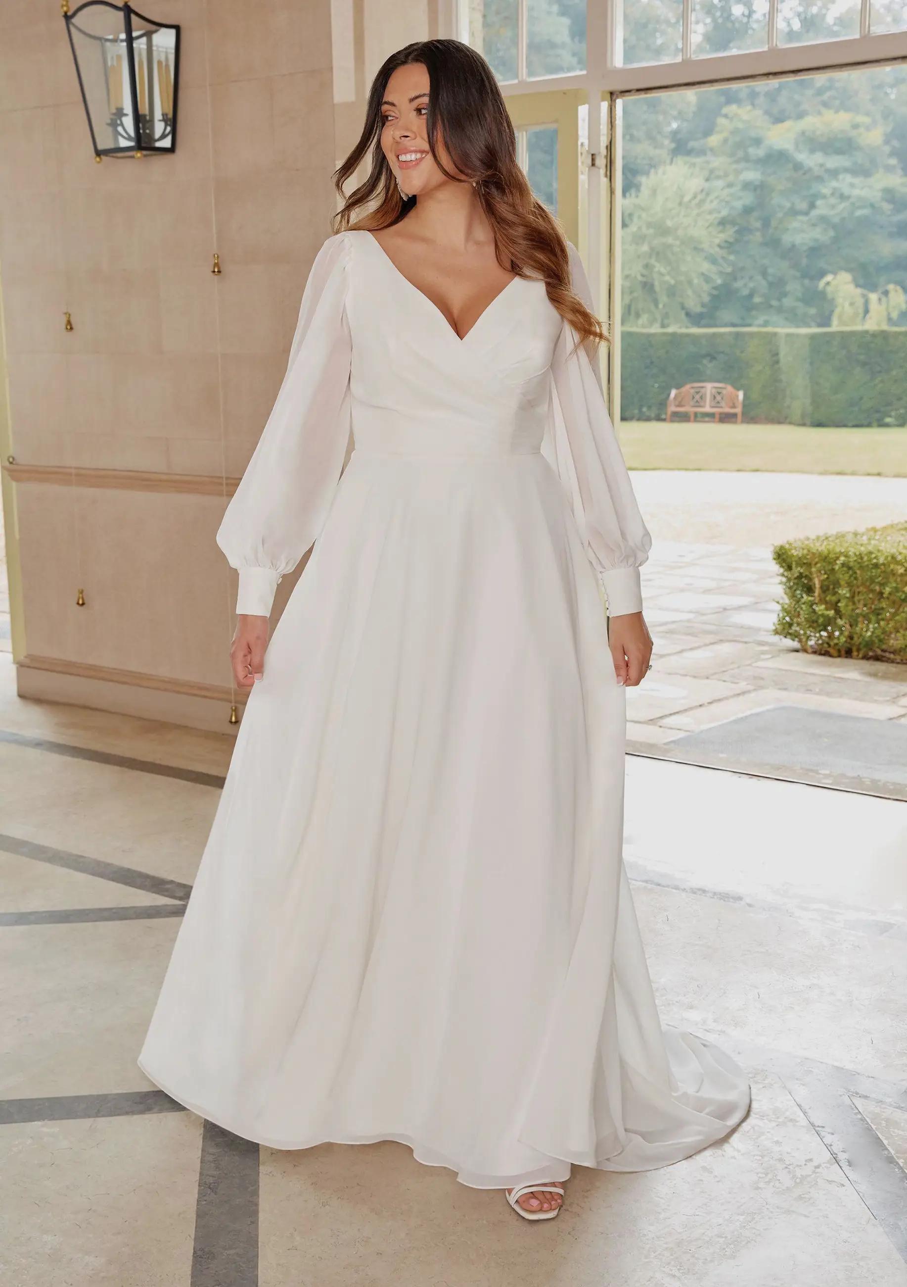 Plus size model wearing a white gown