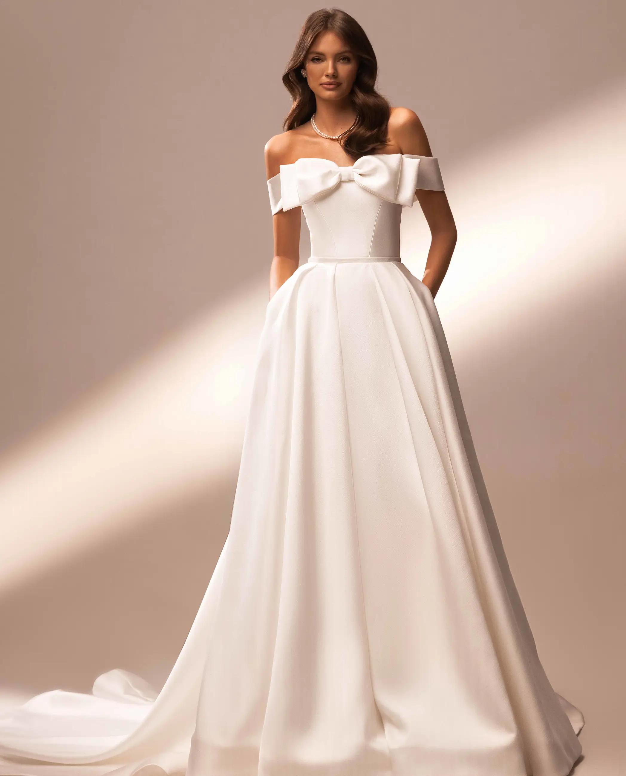 Model wearing a white Katy Corso Dress